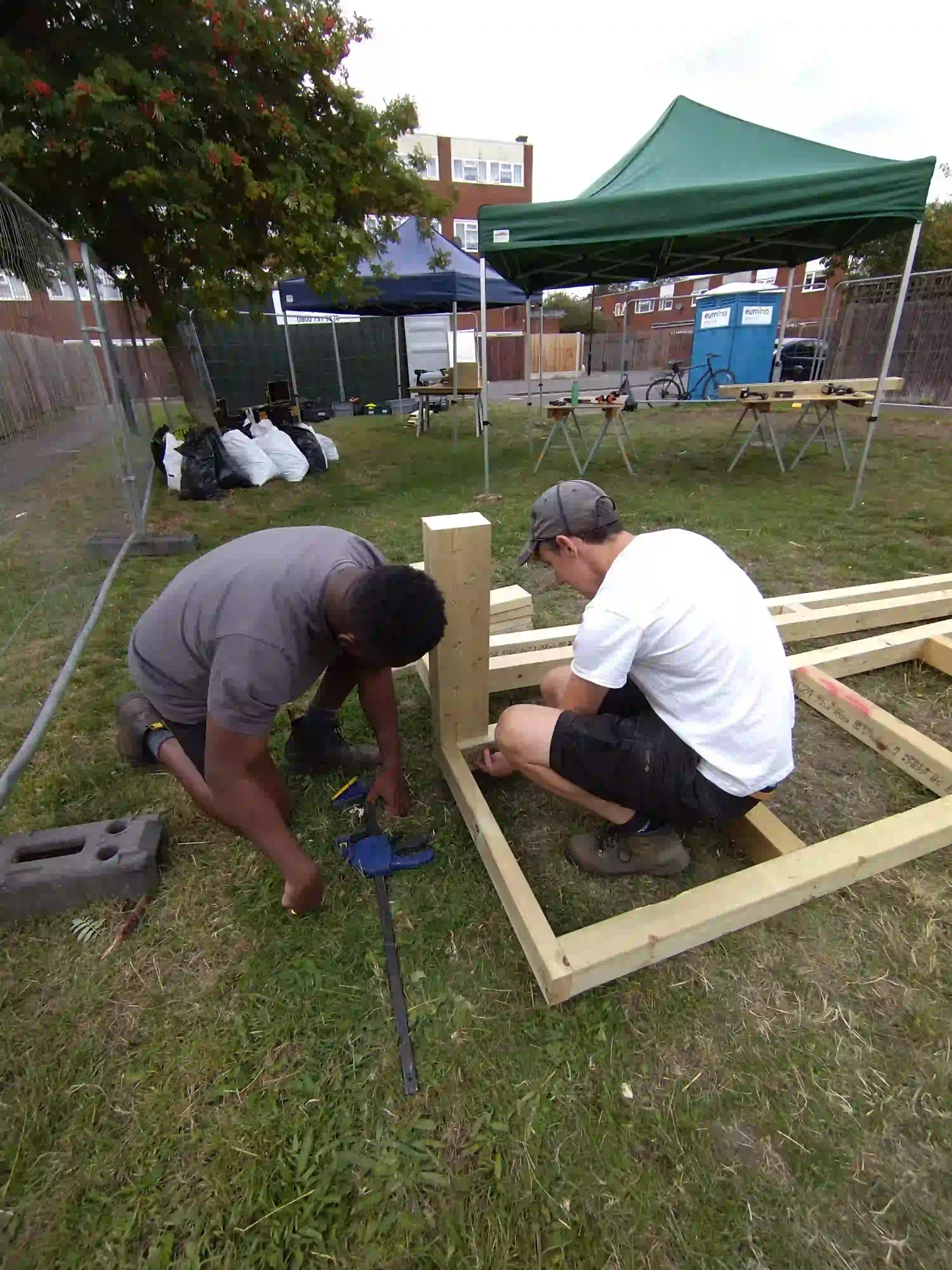 Facilitators using woodworking tools