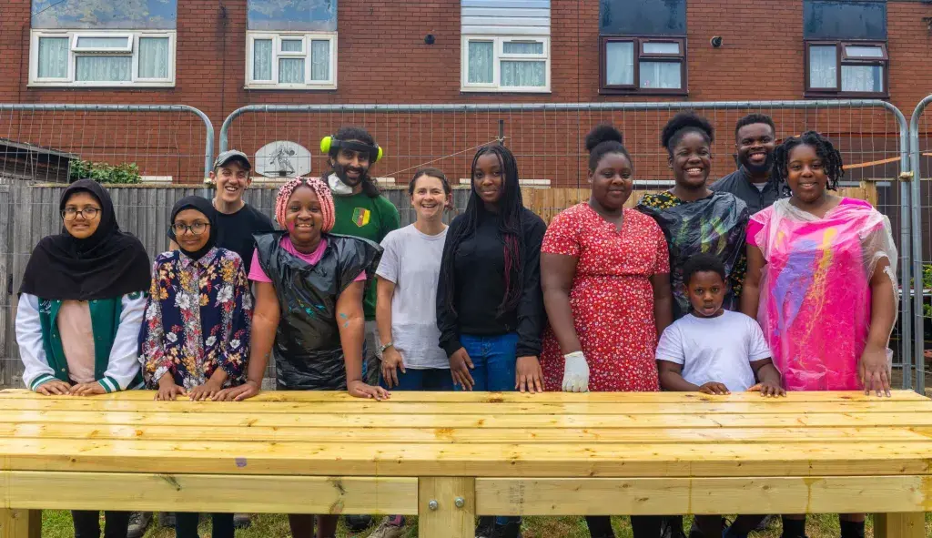 Participants assembling a wooden frame